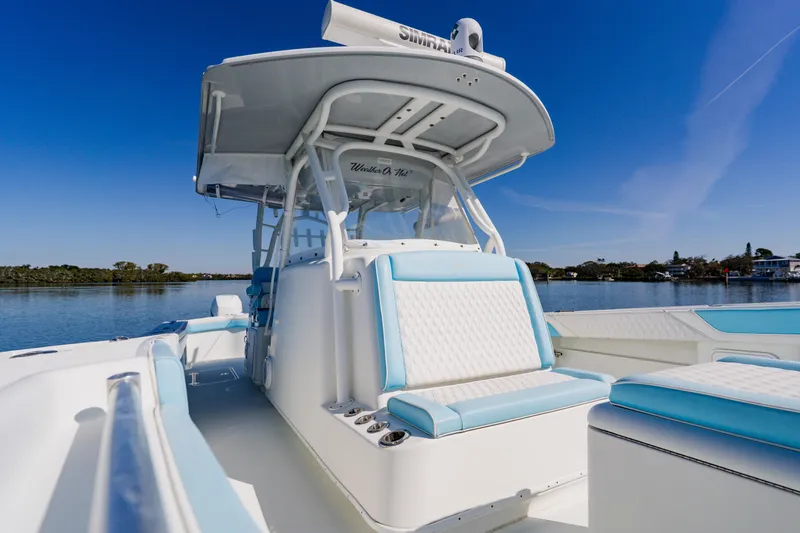  Yacht Photos Pics 2015 Yellowfin 39 Offshore boat with blue and white seating, on calm water.