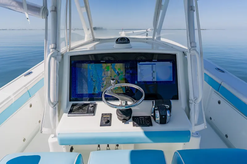  Yacht Photos Pics 2015 Yellowfin 39 Offshore boat dashboard with navigation system on calm water.
