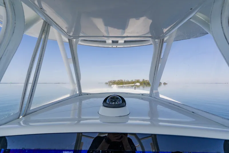  Yacht Photos Pics 2015 Yellowfin 39 Offshore boat navigating calm waters with island view.