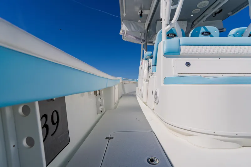  Yacht Photos Pics 2015 Yellowfin 39 Offshore boat interior with blue and white seating under clear sky.