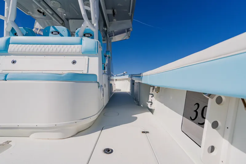  Yacht Photos Pics 2015 Yellowfin 39 Offshore boat interior with blue and white seating under clear sky.
