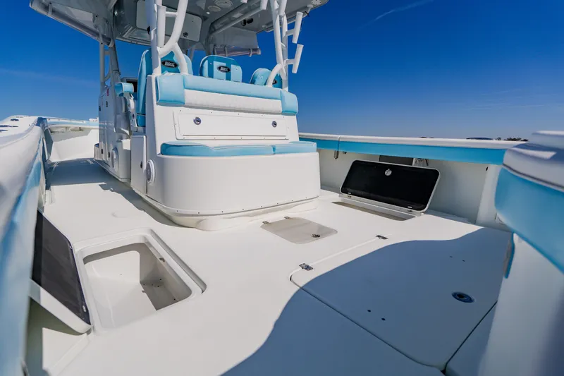  Yacht Photos Pics 2015 Yellowfin 39 Offshore boat interior with blue and white seating under clear sky.