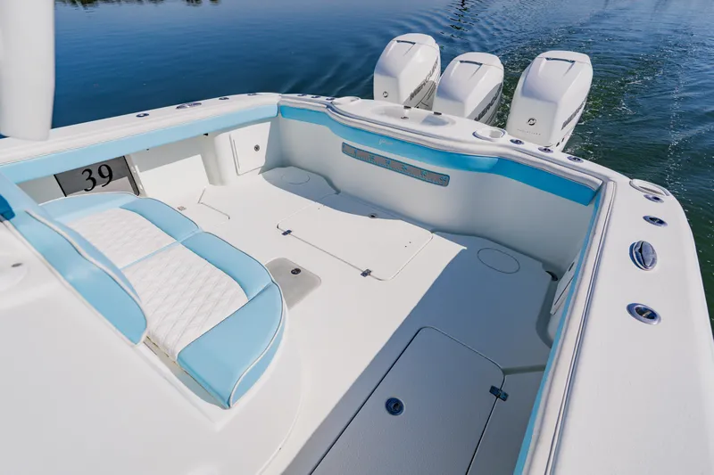  Yacht Photos Pics 2015 Yellowfin 39 Offshore boat interior with triple engines, featuring white and blue seating.