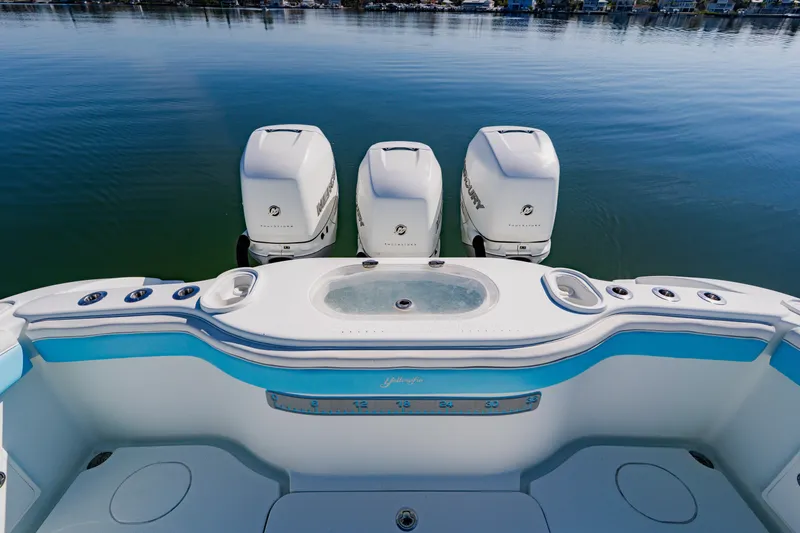  Yacht Photos Pics 2015 Yellowfin 39 Offshore boat with triple Mercury outboard engines on calm water.
