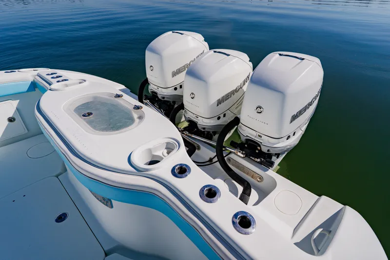  Yacht Photos Pics 2015 Yellowfin 39 Offshore boat with triple Mercury outboard engines on calm water.