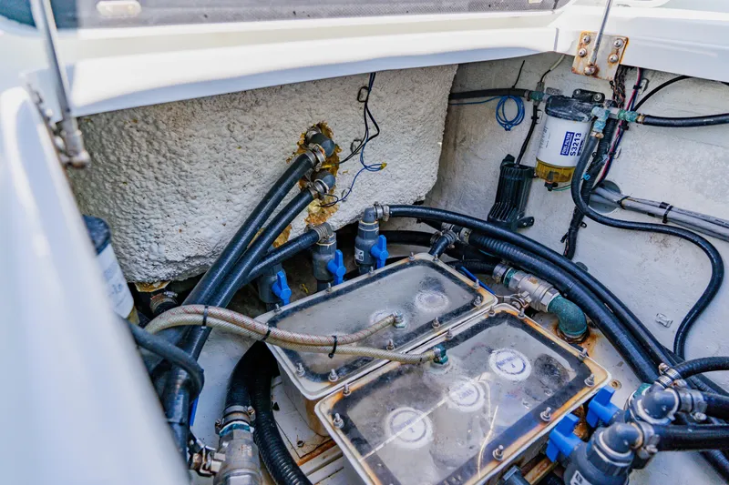  Yacht Photos Pics Engine compartment of a 2015 Yellowfin 39 Offshore boat, showcasing hoses and filters.