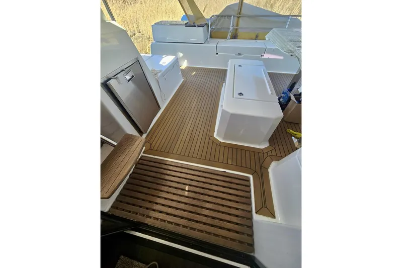 Honu Kai Yacht Photos Pics 2023 Fountaine Pajot Catamaran Astrea 42 deck with wood finish and seating area.