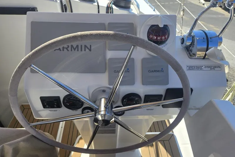 Honu Kai Yacht Photos Pics Steering wheel and controls of 2023 Fountaine Pajot Catamaran Astrea 42 with Garmin navigation.