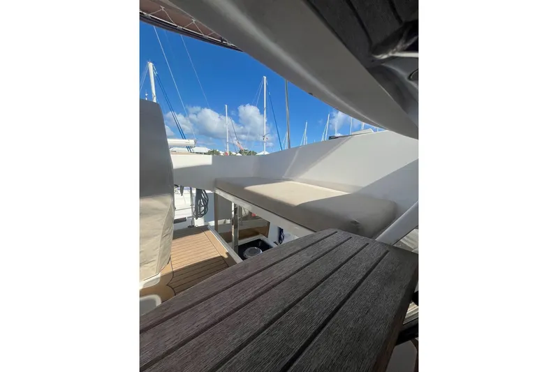 Honu Kai Yacht Photos Pics 2023 Fountaine Pajot Catamaran Astrea 42 deck view with seating and clear blue sky.