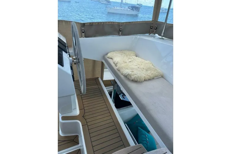 Honu Kai Yacht Photos Pics 2023 Fountaine Pajot Astrea 42 catamaran helm with cozy seating and ocean view.