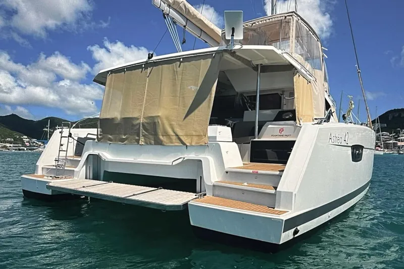 Honu Kai Yacht Photos Pics 2023 Fountaine Pajot Catamaran Astrea 42 on water, rear view with open deck.