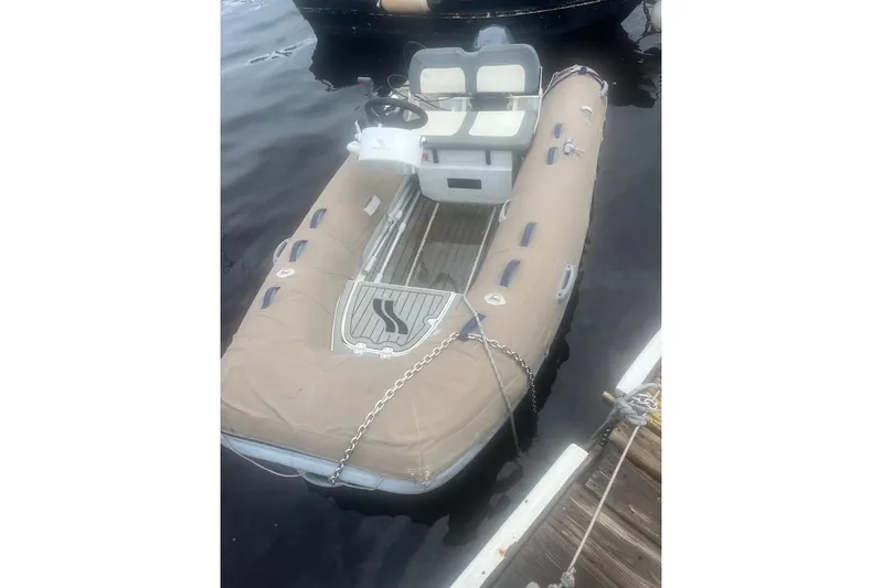 Honu Kai Yacht Photos Pics Inflatable dinghy docked beside a Fountaine Pajot Catamaran Astrea 42, 2023 model.
