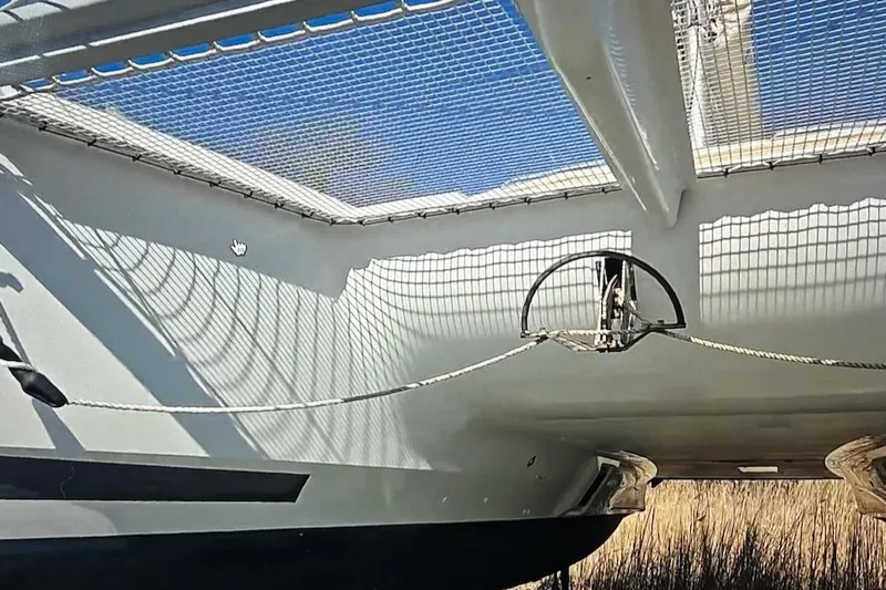 Honu Kai Yacht Photos Pics 2023 Fountaine Pajot Catamaran Astrea 42, featuring netting and sleek design elements.