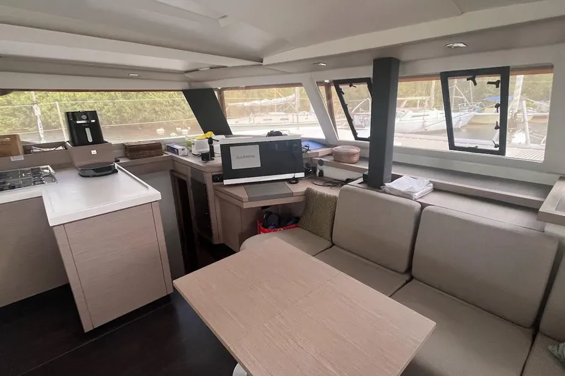 Honu Kai Yacht Photos Pics Interior of 2023 Fountaine Pajot Catamaran Astrea 42 with modern kitchen and seating area.