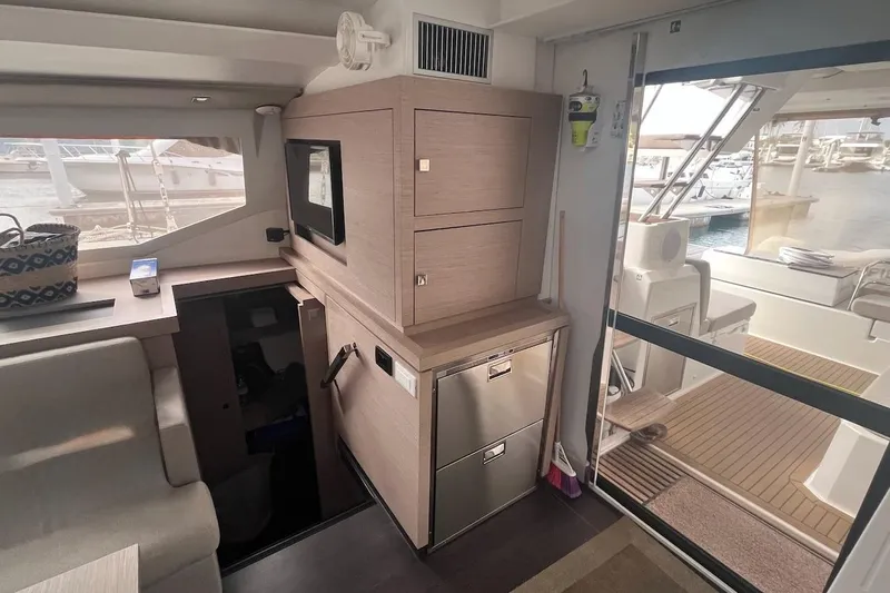 Honu Kai Yacht Photos Pics Interior of 2023 Fountaine Pajot Catamaran Astrea 42, featuring modern cabinetry and outdoor view.