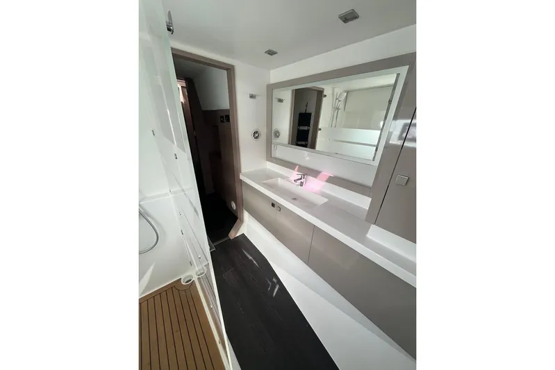 Honu Kai Yacht Photos Pics Modern bathroom in 2023 Fountaine Pajot Catamaran Astrea 42, featuring sleek design and spacious layout.
