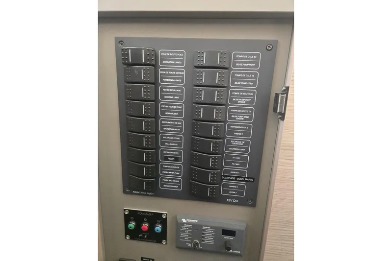 Honu Kai Yacht Photos Pics Control panel of 2023 Fountaine Pajot Catamaran Astrea 42, featuring labeled switches and buttons.