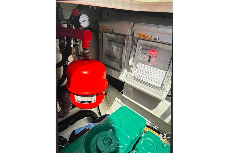 Honu Kai Yacht Photos Pics Engine room of 2023 Fountaine Pajot Catamaran Astrea 42 with red pressure tank and control panels.