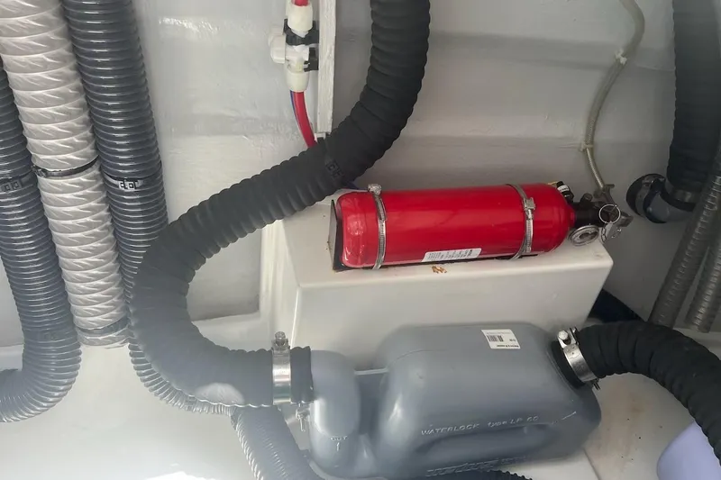 Honu Kai Yacht Photos Pics Engine room of 2023 Fountaine Pajot Catamaran Astrea 42 with fire extinguisher and hoses.