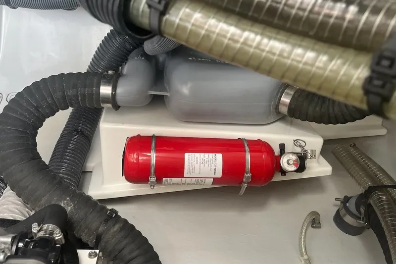 Honu Kai Yacht Photos Pics Engine compartment of 2023 Fountaine Pajot Catamaran Astrea 42 with fire extinguisher and hoses.