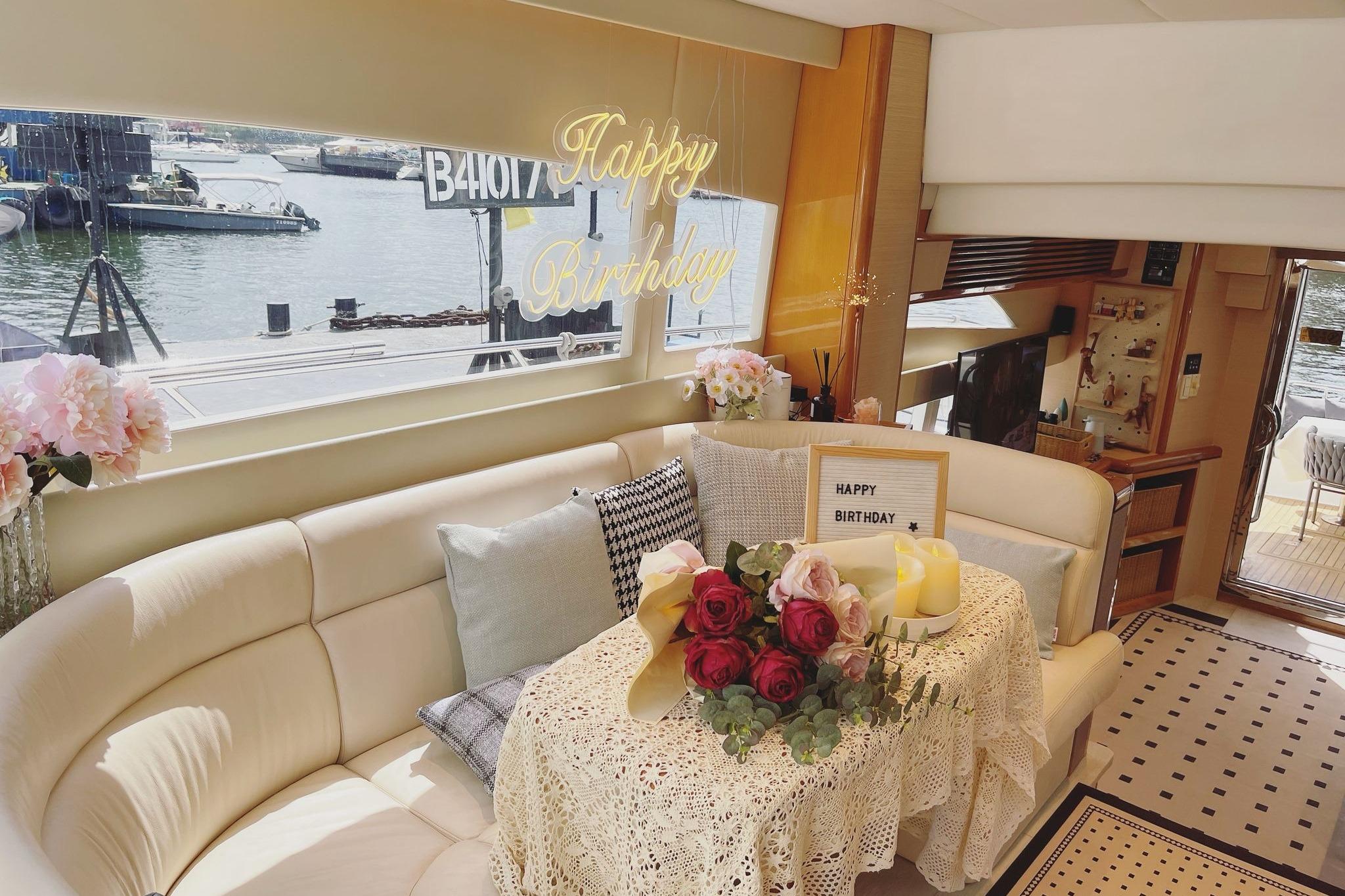 Luxurious yacht interior with birthday decorations, flowers, and candles, Ruby 55 model, 2007.
