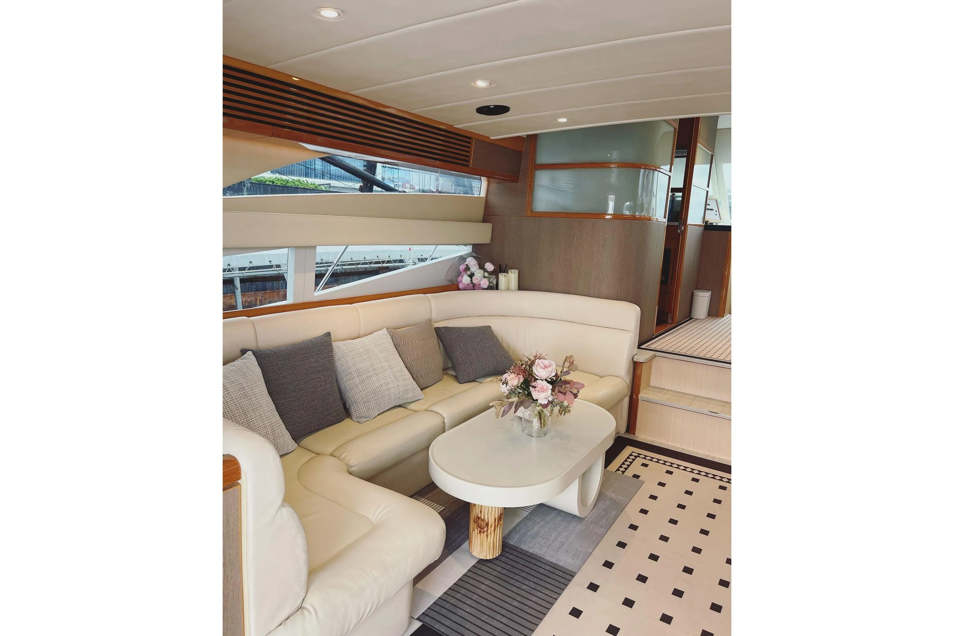 Luxurious interior of 2007 Ruby 55 yacht with elegant seating and floral centerpiece.