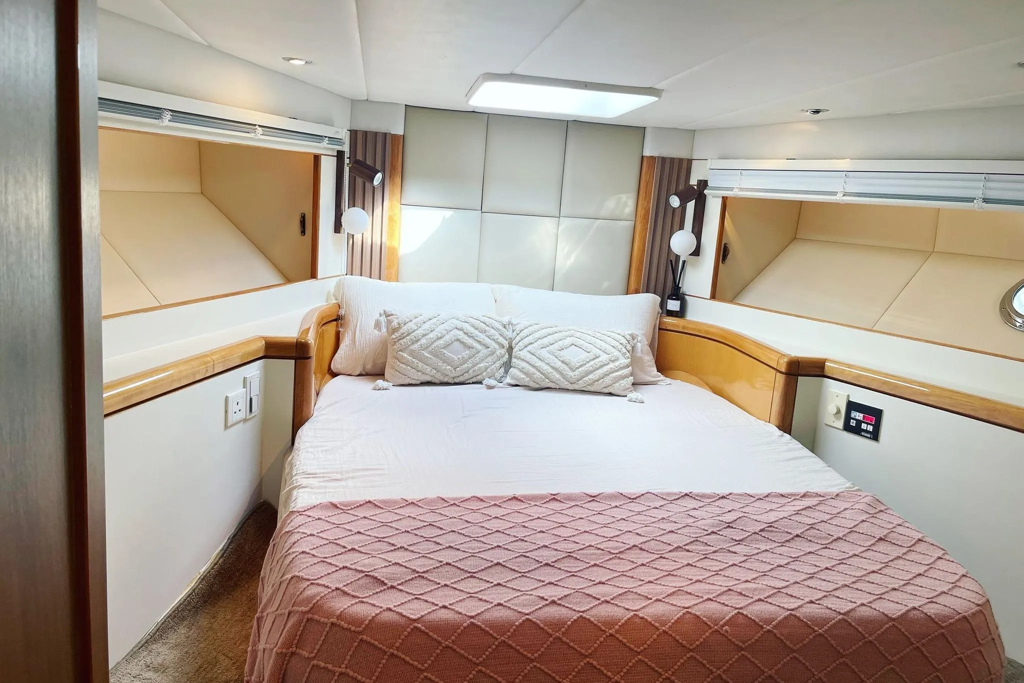 Luxurious bedroom interior in a 2007 Ruby 55 yacht, featuring elegant bedding and modern lighting.