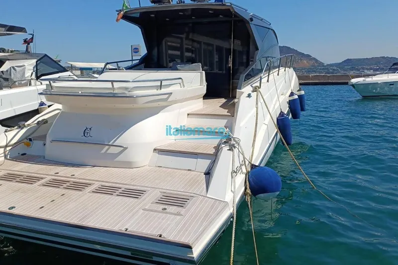  Yacht Photos Pics Luxury 2017 Fiart 52 yacht docked in a marina, featuring sleek design and spacious deck.