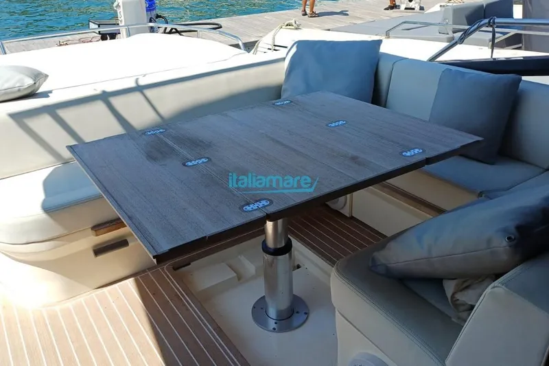 Yacht Photos Pics Luxurious seating area on a 2017 Fiart 52 yacht with a wooden table.