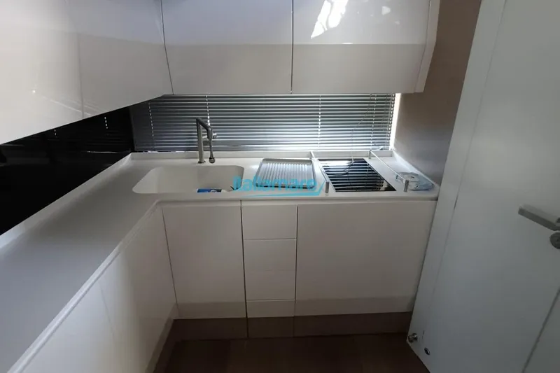  Yacht Photos Pics Modern kitchen interior in a 2017 Fiart 52 yacht, featuring sleek cabinetry and appliances.