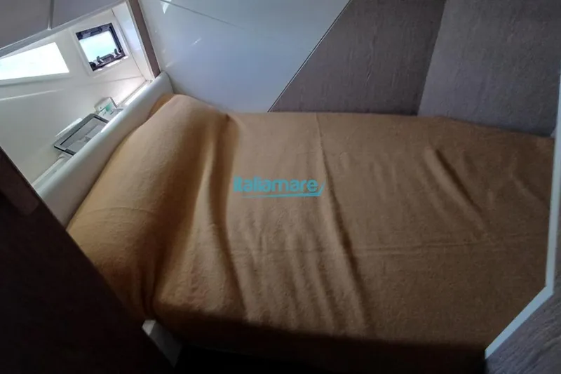  Yacht Photos Pics Cozy cabin interior of 2017 Fiart 52 yacht with a neatly made bed.