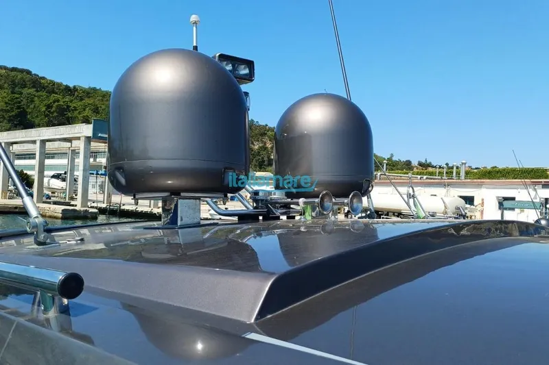  Yacht Photos Pics 2017 Fiart 52 yacht with radar domes, docked in a marina under clear blue sky.