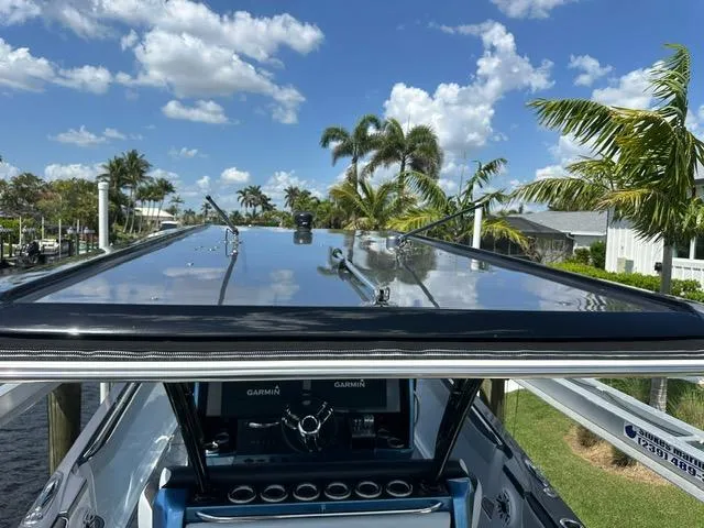  Yacht Photos Pics 2024 Nor-Tech 390 Sport boat with sleek design, docked under a sunny sky.