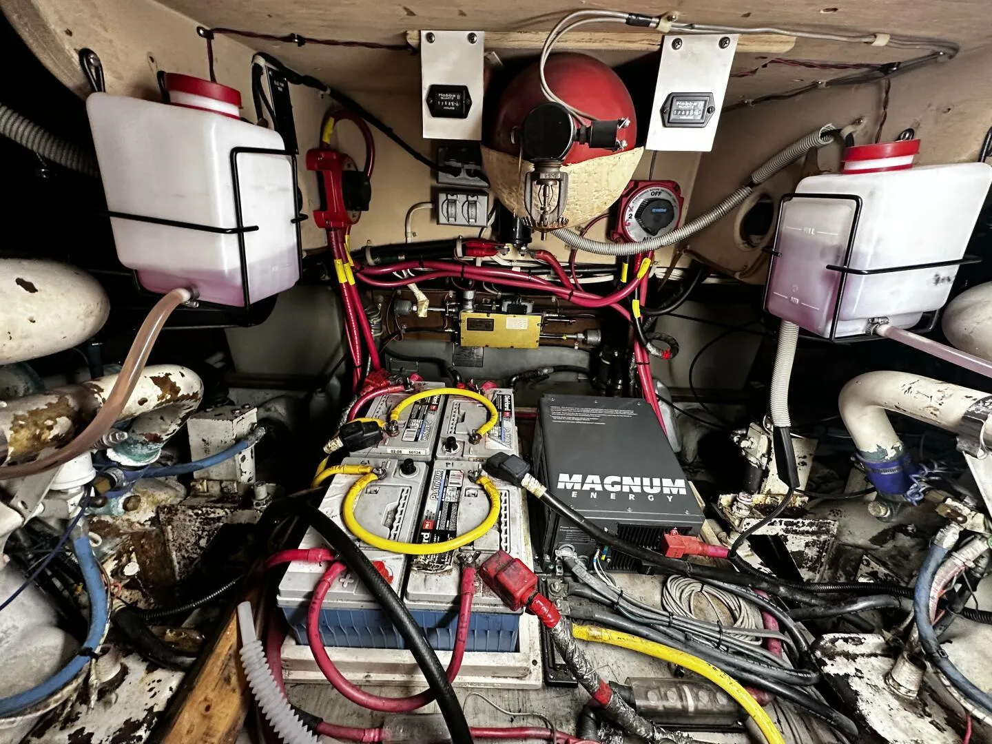 Engine room of a 1985 Post 43 Sport Fisherman with batteries and wiring.