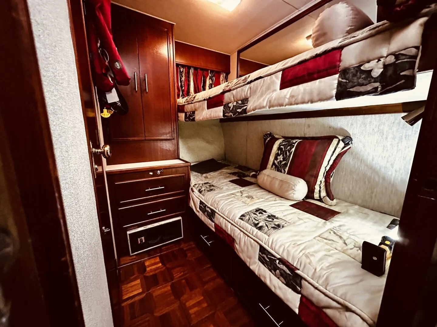 Cozy cabin interior of 1985 Post 43 Sport Fisherman with bunk beds and wooden cabinetry.