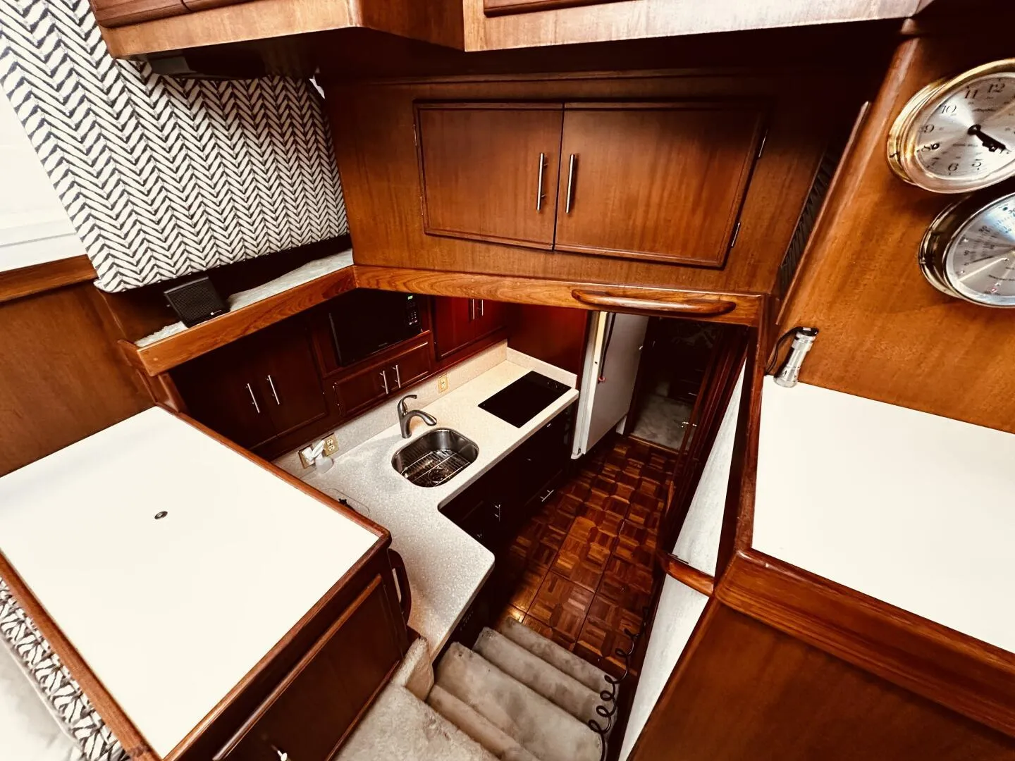 1985 Post 43 Sport Fisherman yacht interior with wood cabinetry and compact kitchen area.
