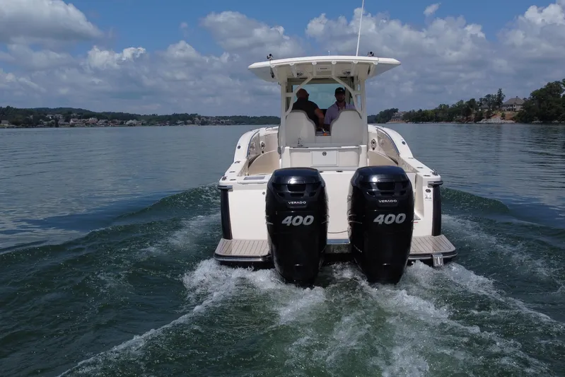  Yacht Photos Pics 2021 Scout 330 LXF boat cruising on a lake with twin 400 Verado engines.