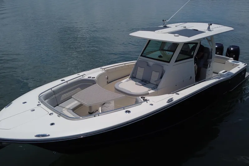  Yacht Photos Pics 2021 Scout 330 LXF boat on calm water, featuring sleek design and spacious deck.