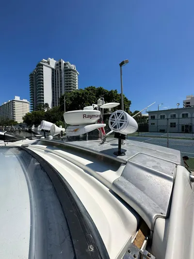 Zuri Yacht Photos Pics 2007 Cranchi Mediterranee 50 HT yacht with Raymarine radar, docked near high-rise buildings.