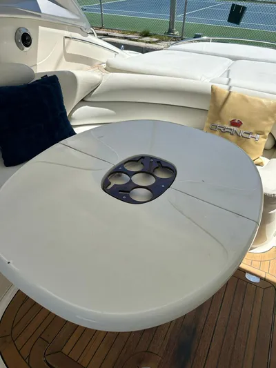Zuri Yacht Photos Pics Luxury seating area on 2007 Cranchi Mediterranee 50 HT yacht with table and cushions.