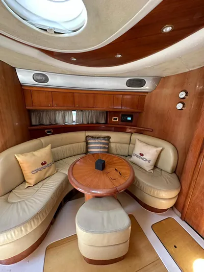 Zuri Yacht Photos Pics 2007 Cranchi Mediterranee 50 HT yacht interior with curved seating and wooden table.