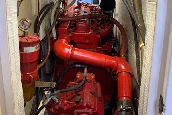  Yacht Photos Pics Red marine engine in a 1988 Ocean Custom boat, featuring pipes and gauges.