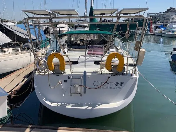  Yacht Photos Pics Sailboat "Cheyenne" docked at marina, Ocean Custom 1988 model, with solar panels and lifebuoys.