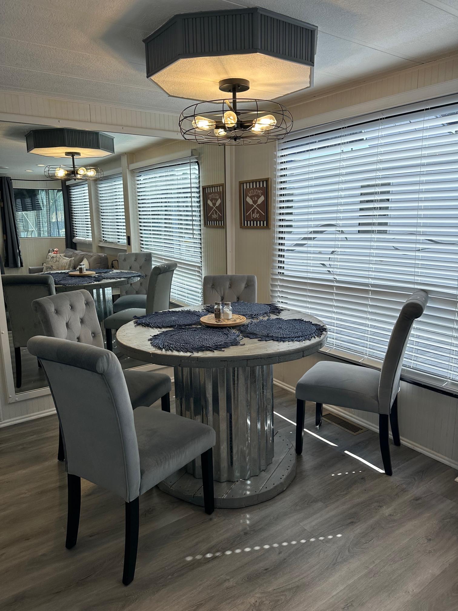 Dining area in a 1995 Lakeview model, featuring modern decor and elegant seating.