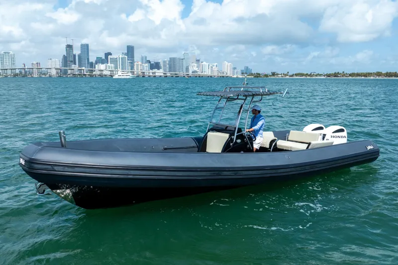  Yacht Photos Pics 2023 Sea Water PHANTOM 280 boat cruising near city skyline on a sunny day.