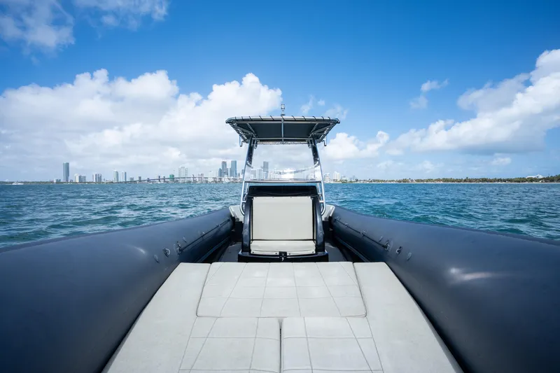  Yacht Photos Pics 2023 Sea Water PHANTOM 280 boat cruising on blue ocean with city skyline.