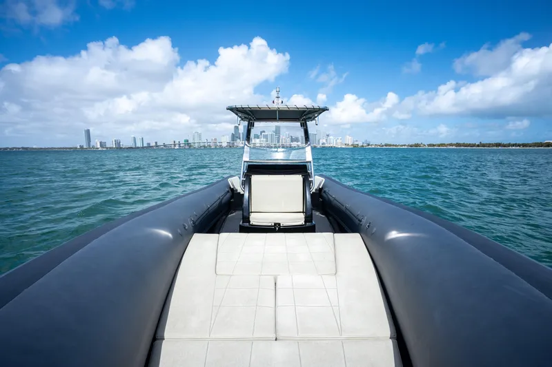  Yacht Photos Pics 2023 Sea Water PHANTOM 280 boat cruising on blue ocean with city skyline.