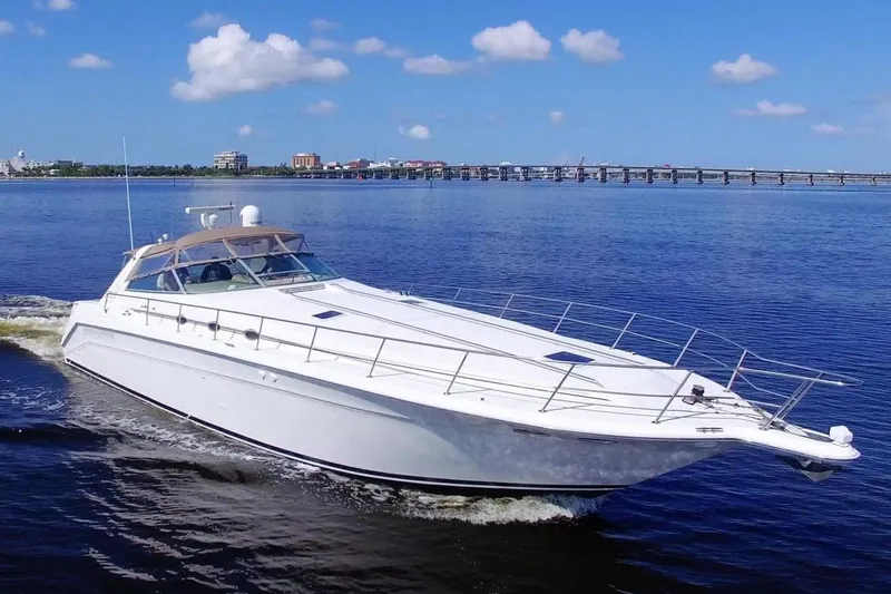  Yacht Photos Pics 1995 Sea Ray 500 Sundancer cruising on a calm blue sea under a clear sky.