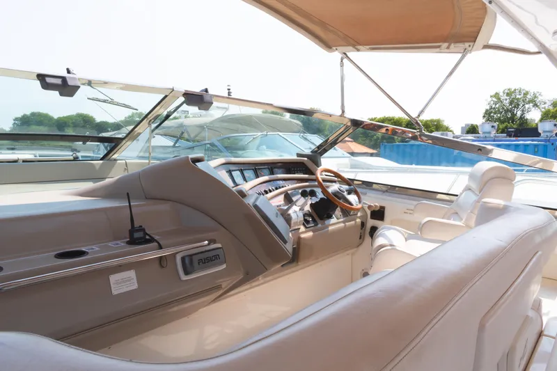  Yacht Photos Pics 1995 Sea Ray 500 Sundancer yacht cockpit with steering wheel and seating.