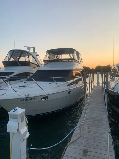 Continuous Wave Yacht Photos Pics 2007 Meridian 391 yacht docked at sunset, alongside other boats.